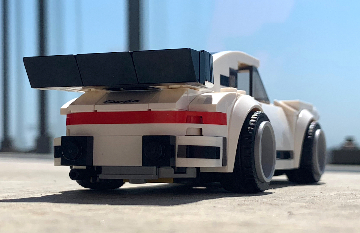 The back of the LEGO Speed Champions 1974 Porsche 911 Turbo. That rear wing/spoiler is huge and hides the cool 'Turbo' badge detailing right above that full-width red rear light strip. Look carefully and you'll see the exhaust pipe and engine undertray details too.