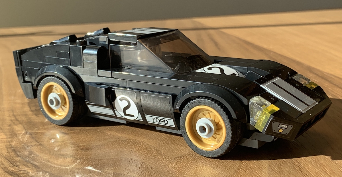 The 1966 Ford GT40 model in black with a grey racing stripe down the center. The stickering is very minor on this model. As a lot is black on black, the model is quite forgiving except in direct light like this. The gold wheels with round tiles for wheel nuts is a nice touch.