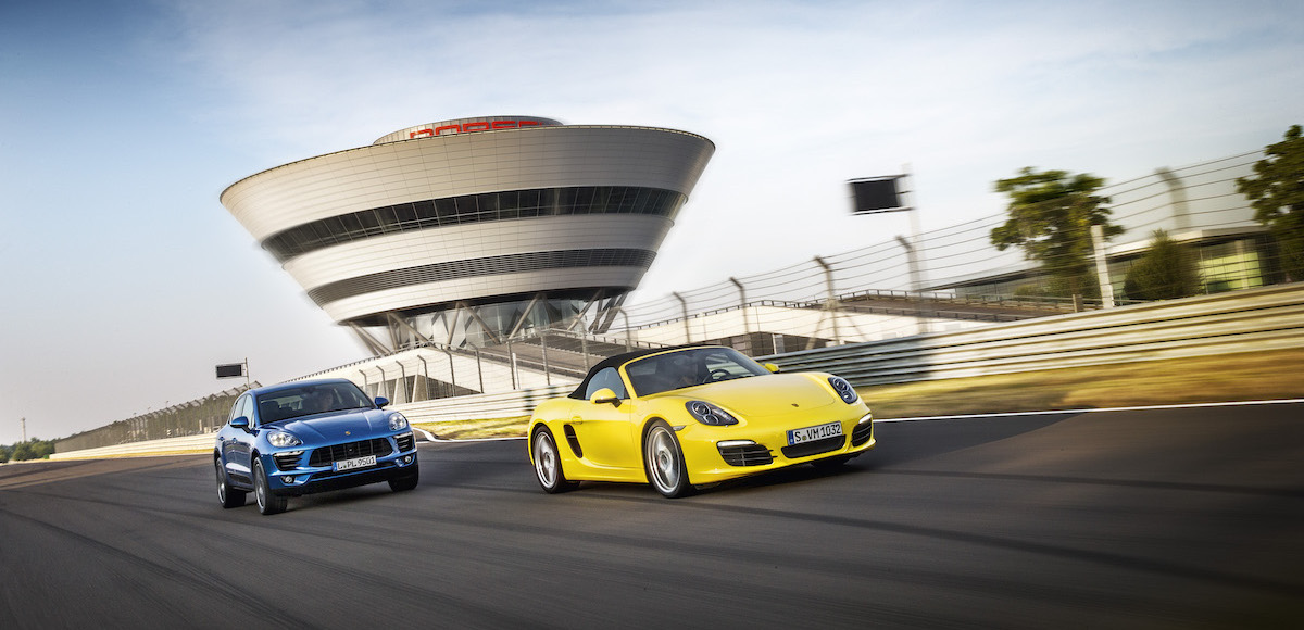 The 'Diamond' at Porsche's Leipzig factory, with the customer center in the foreground playing host to a Porsche Macan and Porsche Cayman.