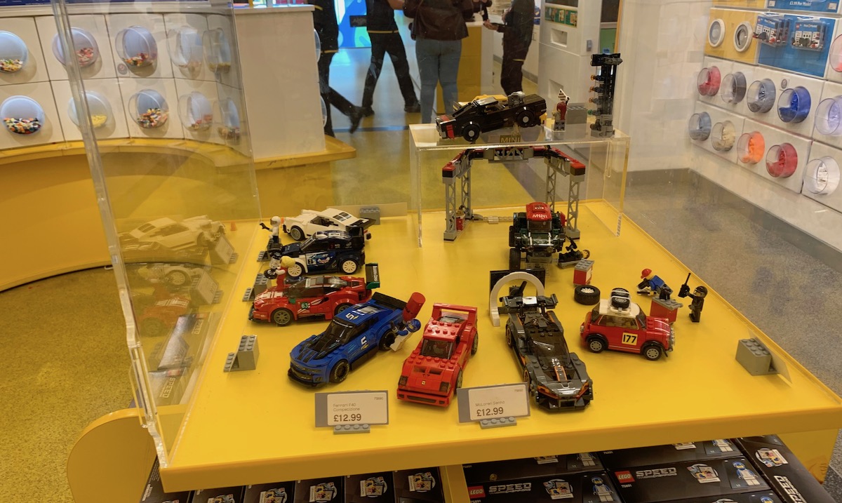 The LEGO Speed Champions display in the flagship store, featuring all of the current sets including the new individual '74 Porsche 911 set 75895.