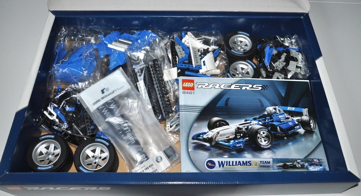 Inside the box of the LEGO Racers BMW WilliamsF1 FW25 Team Racer set, showing the lanyard ticket holder. The build instructions/manual is unchanged from the original 8461 Williams F1 Team Racer set (note the blue rear wing on the manual versus the white one on the box).