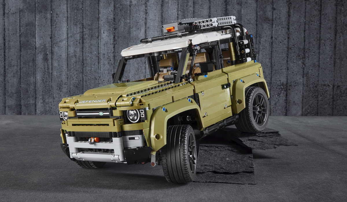 Official images of the LEGO Technic Land Rover Defender, set 42110. The model has great detailing with the DEFENDER sticker on the hood, tow hook and two-tone roof with side windows.