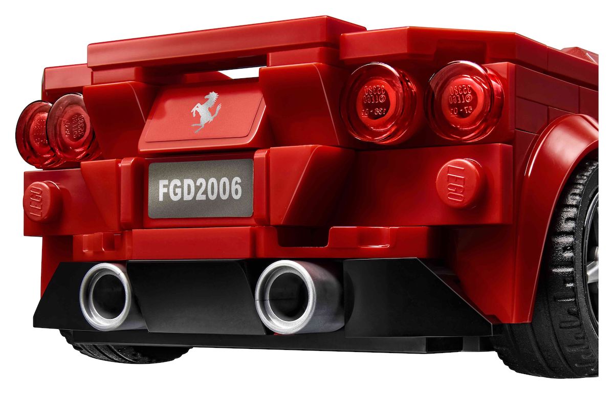 The rear of the Speed Champions Ferrari F8 Tributo, with the iconic 4 rear lights - Ferrari badge and licence plate stickers and two beefy tailpipes. The new diffuser style, using the sloped, rounded corners sideways on the bottom of the model looks great.