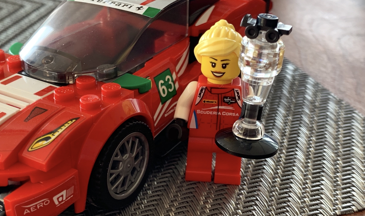 This blonde minifigure represents Christina Nielsen, back to back GT Daytona winner in the IMSA Sportscar series and driver of the #69 Scuderia Corsa Ferrari 488 GT3 in period, back in 2017. The trophy uses a clear minifigure head on top of a cup, which is slightly weird...