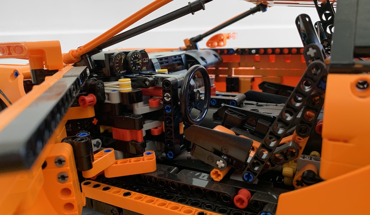 The dashboard of the Lego 911 GT3RS showing the realistic looking dials built using 1x1 circular plates, the transmission shift paddles behind the steering wheel replicating PDK and the Porsche crest on the centre of the steering wheel.